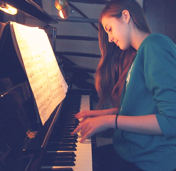 girl practicing piano